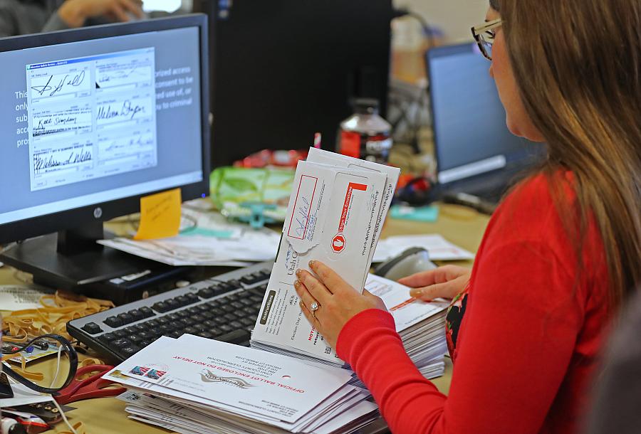 Verifying ballots in Utah, where 53 percent of voters supported expanding Medicaid.