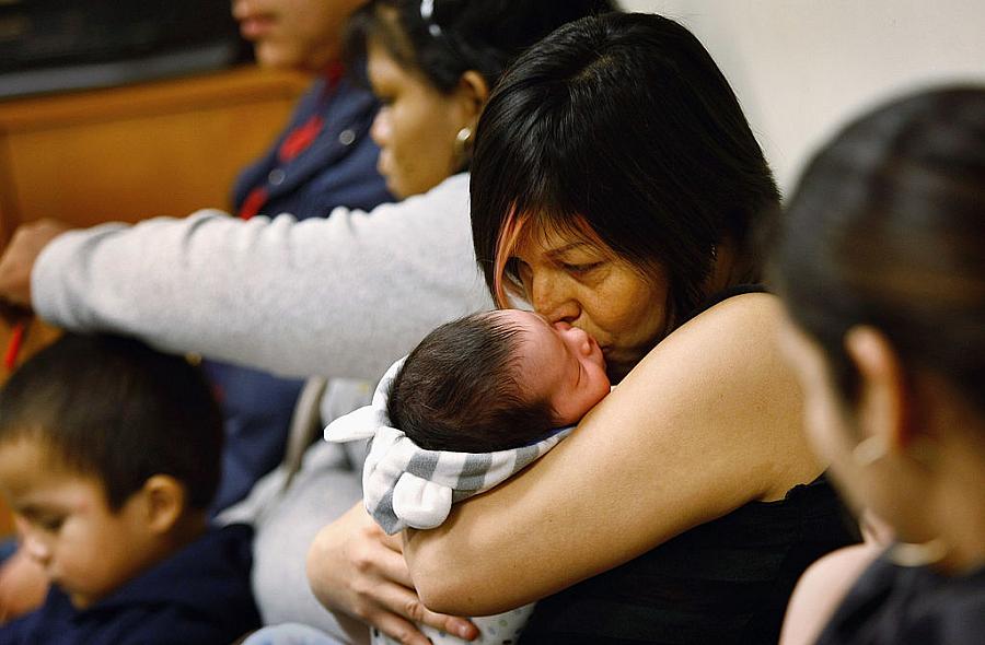 An uninsured mother and child at a community health center for low-income patients in Colorado. An uninsured mother and child at a community health center for low-income patients in Colorado.