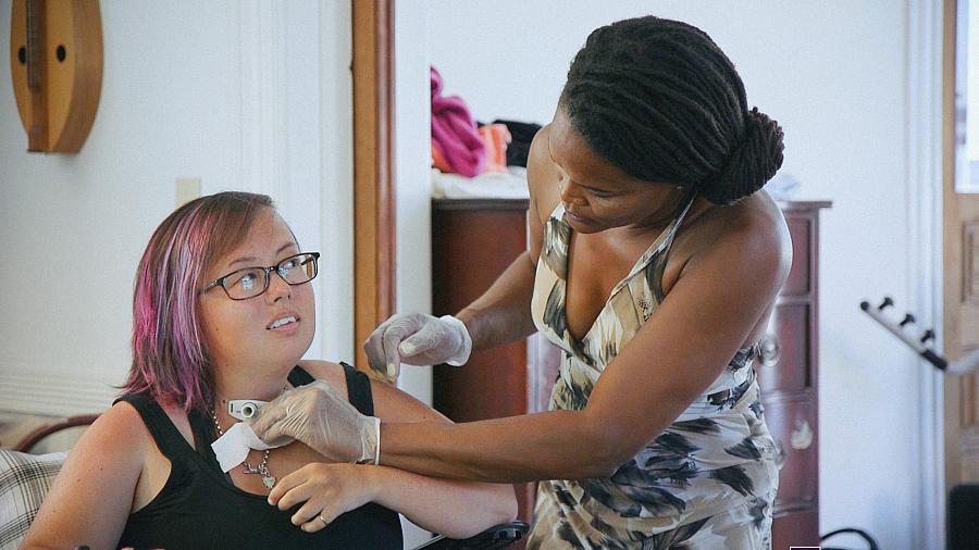 Stacey Milbern of Oakland, California relies on Medicaid-funded attendants to get out of bed, eat, bathe, and get around.