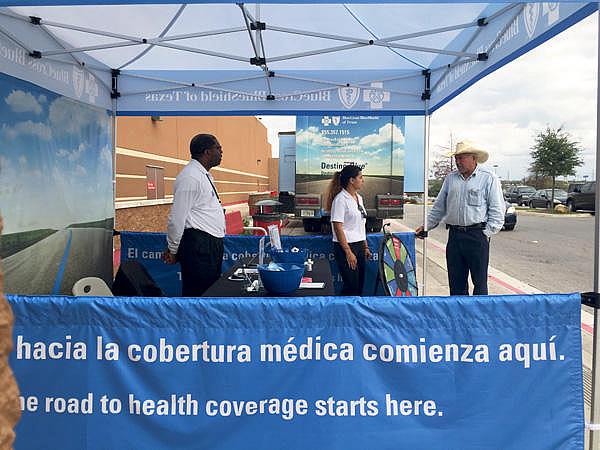 Insurance agents working with Blue Cross Blue Shield of Texas answered questions outside of a Target in San Antonio. (Veronica Zaragovia/KUT) Insurance agents working with Blue Cross Blue Shield of Texas answered questions outside of a Target in San Antonio. (Veronica Zaragovia/KUT)