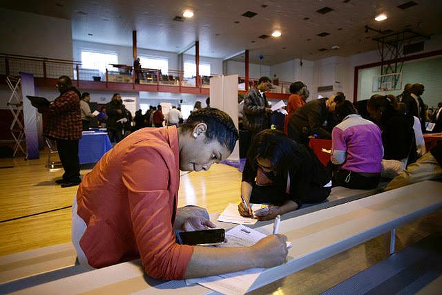 Women attend a jobs fair in Detroit, Michigan. The state is currently considering a bill requiring 29 hours a week of work activities to qualify for Medicaid. (Photo by Joshua Lott/Getty Images) Photo by Joshua Lott/Getty Images