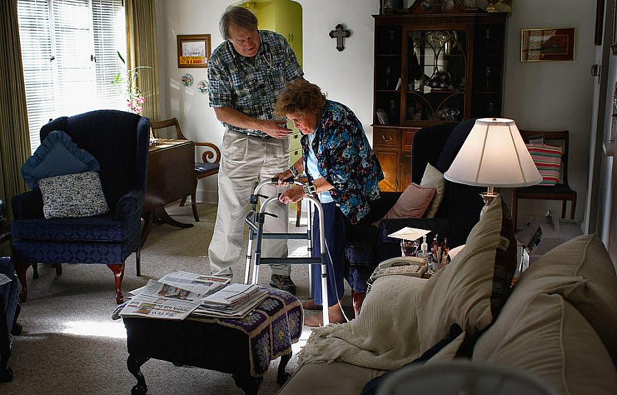 Nurse Stephen Van Dyke helps Mary Donahue, 100, with her exercises in her Denver home. A local nonprofit provides free home nurs