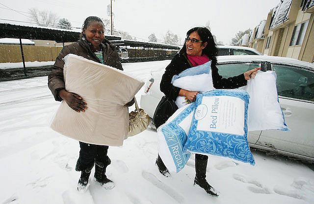 Women of the World founder Samira Harnish, right, delivers bedding to refugee Ngakoutou in Salt Lake City Wednesday, Dec. 11, 2013. Harnish came to America from Iraq in the 1970s. 