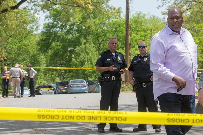 Former Little Rock Police Chief Kenton Buckner walks past crime scene tape at the scene of a double shooting at 27th Street and Washington Street after two 16-year-olds were shot while driving a stolen car April 9, 2017.
