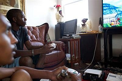 Roosevelt and his family enjoy video games in the family home. Andrew Nixon/Capital Public Radio