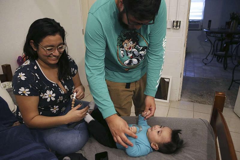 Abraham Saavedra plays with son Samuel Saavedra as Linda Martinez watches. Martinez, who’s now a doula, says she wants to make sure that other mothers know they can speak up in the delivery room. JERRY LARA/STAFF PHOTOGRAPHER