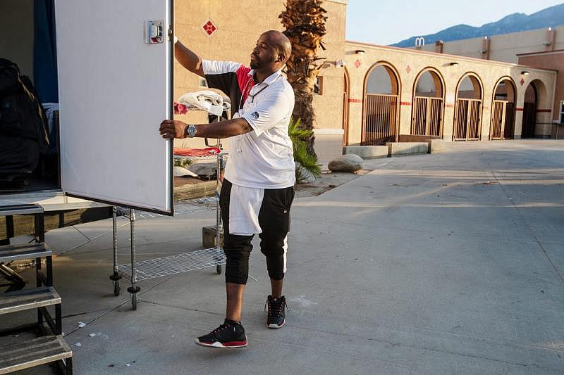 Coachella Valley Rescue Mission employee Charles Dangerfield the third closes the door to the portable shower used by guest staying at the emergency overnight shelter run by the Coachella Valley Rescue Mission inside a portion of the Palm Springs High School Gymnasium on Saturday , June 27, 2020. Taya Gray, Taya Gray Coachella Valley Rescue Mission employee Charles Dangerfield the third closes the door to the portable shower used by guest staying at the emergency overnight shelter run by the Coachella Valley Rescue Mission inside a portion of the Palm Springs High School Gymnasium on Saturday , June 27, 2020. Taya Gray, Taya Gray