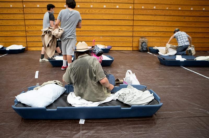 Janos Szilagyi, 39, center sits on his mattress inside the emergency overnight shelter run by the Coachella Valley Rescue Mission inside a portion of the Palm Springs High School Gymnasium on Saturday , June 27, 2020. Taya Gray, Taya Gray Janos Szilagyi, 39, center sits on his mattress inside the emergency overnight shelter run by the Coachella Valley Rescue Mission inside a portion of the Palm Springs High School Gymnasium on Saturday , June 27, 2020. Taya Gray, Taya Gray