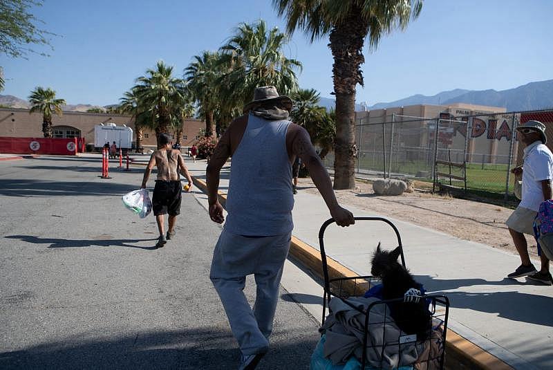 Johnny Alvarez, 47, center, walks toward the emergency overnight shelter run by the Coachella Valley Rescue Mission inside a portion of the Palm Springs High School Gymnasium on Saturday , June 27, 2020. Taya Gray, Taya Gray Johnny Alvarez, 47, center, walks toward the emergency overnight shelter run by the Coachella Valley Rescue Mission inside a portion of the Palm Springs High School Gymnasium on Saturday , June 27, 2020. Taya Gray, Taya Gray