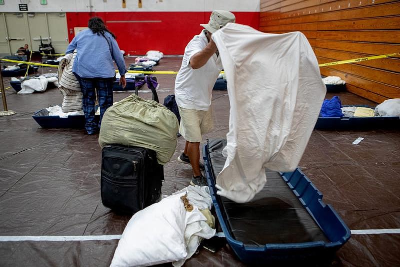 People place clean sheets on their mattress inside the emergency overnight shelter run by the Coachella Valley Rescue Mission inside a portion of the Palm Springs High School Gymnasium on Saturday , June 27, 2020. Taya Gray, Taya Gray People place clean sheets on their mattress inside the emergency overnight shelter run by the Coachella Valley Rescue Mission inside a portion of the Palm Springs High School Gymnasium on Saturday , June 27, 2020. Taya Gray, Taya Gray
