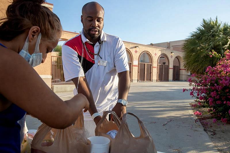 Coachella Valley Rescue Mission employee Charles Dangerfield the third, right, checks in a guest to the emergency overnight shelter run by the Coachella Valley Rescue Mission inside a portion of the Palm Springs High School Gymnasium on Saturday , June 27, 2020. Taya Gray, Taya Gray Coachella Valley Rescue Mission employee Charles Dangerfield the third, right, checks in a guest to the emergency overnight shelter run by the Coachella Valley Rescue Mission inside a portion of the Palm Springs High School Gymnasium on Saturday , June 27, 2020. Taya Gray, Taya Gray