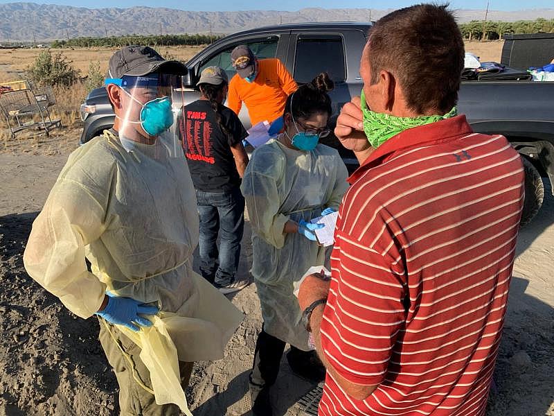 Congressman Raul Ruiz talks with an individual experiencing homelessness in the eastern Coachella Valley before testing him for COVID-19. Ruiz worked with the Coachella Valley Volunteers in Medicine to bring testing to the streets. Hernan Quintas Congressman Raul Ruiz talks with an individual experiencing homelessness in the eastern Coachella Valley before testing him for COVID-19. Ruiz worked with the Coachella Valley Volunteers in Medicine to bring testing to the streets. Hernan Quintas