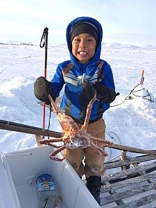 Six-year-old Trevor White with his catch of the day. A resident of western Alaska, White has been learning how to hunt, fish and store traditional foods from his Alaska Native relatives.