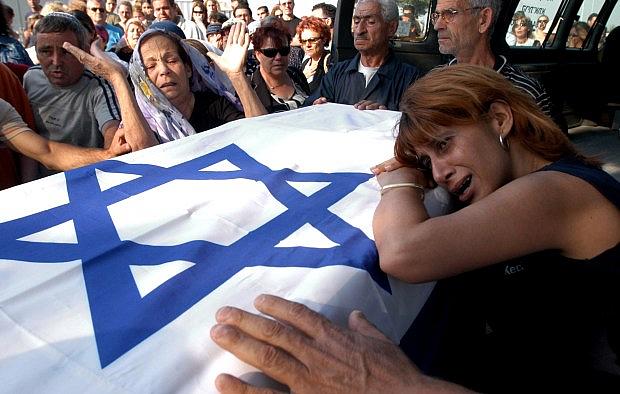 Relatives of Bat-El Ohana carry her coffin during her funeral in the cemetery of Kiryat Atta, near the northern city of Haifa, Israel, Thursday, June 12, 2003. Ohana, 21, was one of 16 people killed in Wednesday, June 11’s bus bombing in Jerusalem. (AP Photo/ Baz Ratner)