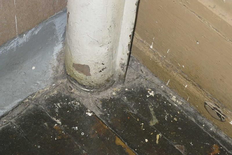 A sample of settled dust taken in January from the floor around this hallway pipe near a sixth-grade classroom at Olney Elementary tested at 8.5 million asbestos fibers. The asbestos pipe is partially encased in a metal jacket.