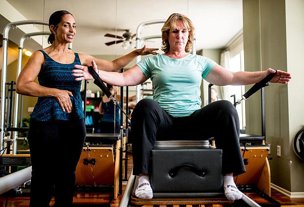 Julie Swann-Paez, a survivor of the Dec. 2 San Bernardino shooting, works with Pilates instructor Valerie Chargois to strengthen muscles during her recovery at Pilates 909 in Rancho Cucamonga on Saturday, July 15, 2017. Swann-Paez was shot twice in the pelvis during the terror attack. (Photo by Watchara Phomicinda, The Press-Enterprise/SCNG