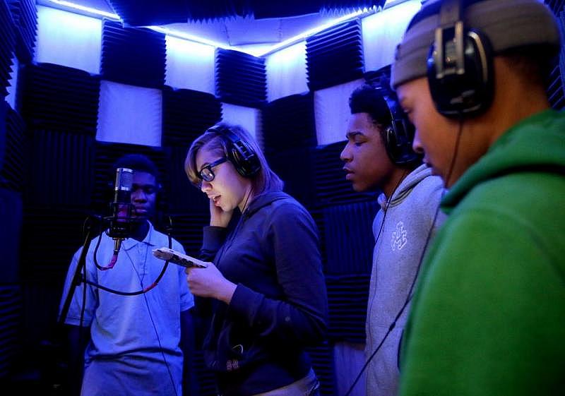 Students at MC2STEM High School use a sound booth to record songs they've been working on that share perspective on issues they face in their community and care about. From left to right are: Travon Sellers, Kieara Clay, Andre Cook, and Anthony Moten. (Marvin Fong / The Plain Dealer)