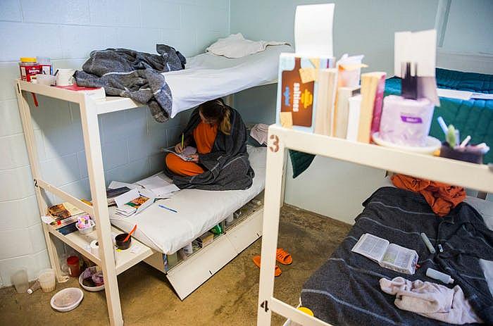 Inmate Beth Wesner, 25, sketches on her bunk at the Burnet County Jail in October. The jail had one of the most significant increases in female inmates in Texas, largely because it houses women for other counties that have run out of room.  (Ashley Landis/Staff Photographer)