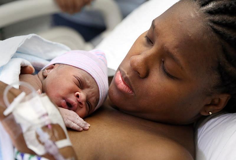 Alisha Samuel, 31, holds her new baby daughter Bailey Amira Mae Robertson just minutes after she was born July 14th.  (Lisa DeJong, The Plain Dealer)