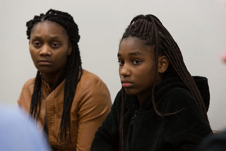 Connie White, left, and her daughter, Lataevia Gaskin, listen during a Restorative Justice Louisville meeting in January 2018.