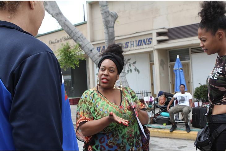 Raena Granberry handing out flyers about the Black Infant Health program at a Black Independence Day event. She goes anywhere from nail salons to doctors offices to do outreach. (Priska Neely/KPCC)