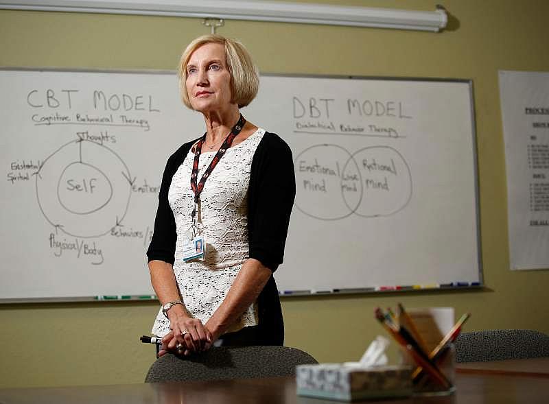 Peg Ledner-Spaulding, LCSW, manager of outpatient behavioral health services poses for a portrait in front on cognitive and dialectical behavior therapy diagrams that illustrate evidence-based tools taught to help people recover from mental illness, at the St. Joseph Health Santa Rosa Memorial Hospital Outpatient Behavioral Health Services clinic in Santa Rosa, California, on Wednesday, August 16, 2017. (Alvin Jornada/The Press Democrat)  Peg Ledner-Spaulding, LCSW, manager of outpatient behavioral health services poses for a portrait in front on cognitive and dialectical behavior therapy diagrams that illustrate evidence-based tools taught to help people recover from mental illness, at the St. Joseph Health Santa Rosa Memorial Hospital Outpatient Behavioral Health Services clinic in Santa Rosa, California, on Wednesday, August 16, 2017. (Alvin Jornada/The Press Democrat)