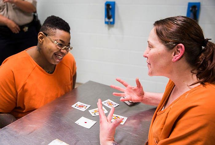 Inmates Sheniqua Miller, 23, (left) and Stacy Jensen, 38, play cards in their unit at the Burnet County Jail. Both women are facing drug charges; Miller has been jailed there since October and Jensen has been in nearly six months. Jensen's bond is set at $300,000.  (Ashley Landis/Staff Photographer)
