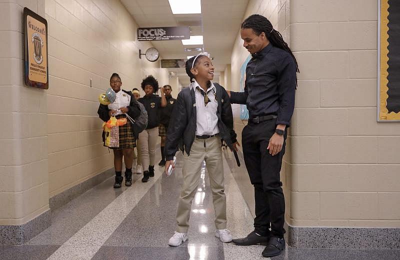 Brennan Jacques greets students before classes at Phillis Wheatley Community School in Treme.