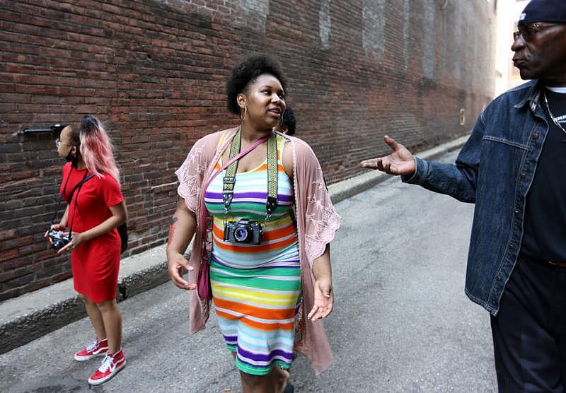 Photo of Air Rodgers, center, explaining the Dear Cleveland project to a man downtown. (Lisa DeJong/The Plain Dealer)