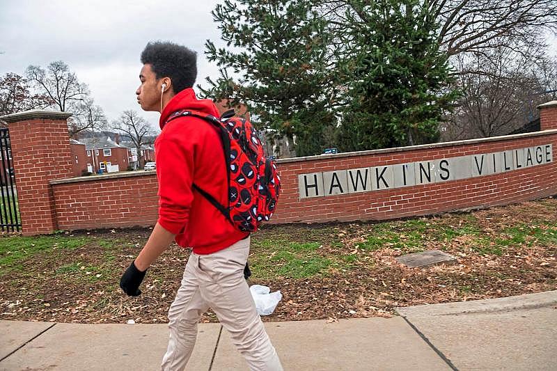 Jared Todd walks home from school after getting off the bus at Hawkins Village in Rankin. Todd's daily routine includes coming straight home and playing video games, drawing — cartoon characters, hands, flowers, things he sees on YouTube — or writing poems.