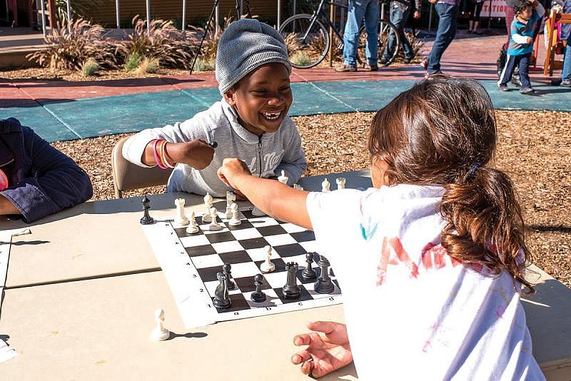 Richmond residents helped design and build the amenities at Elm Playlot — including a fence with profiles of those who helped build the park — as well as create the programming for kids and adults. (Photo courtesy Pogo Park)