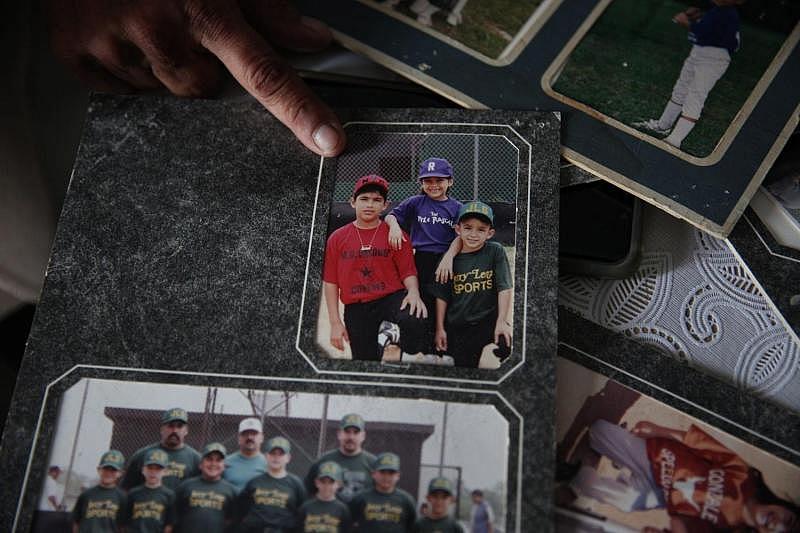 Theresa Martinez, 50, shows old photographs of her kids in Little League. Martinez was involved with the youth sports program in Bloomington for about three decades and is struggling to get youth sports started again. (Photo: Angela Piazza/Victoria Advocate) Theresa Martinez, 50, shows old photographs of her kids in Little League. Martinez was involved with the youth sports program in Bloomington for about three decades and is struggling to get youth sports started again.