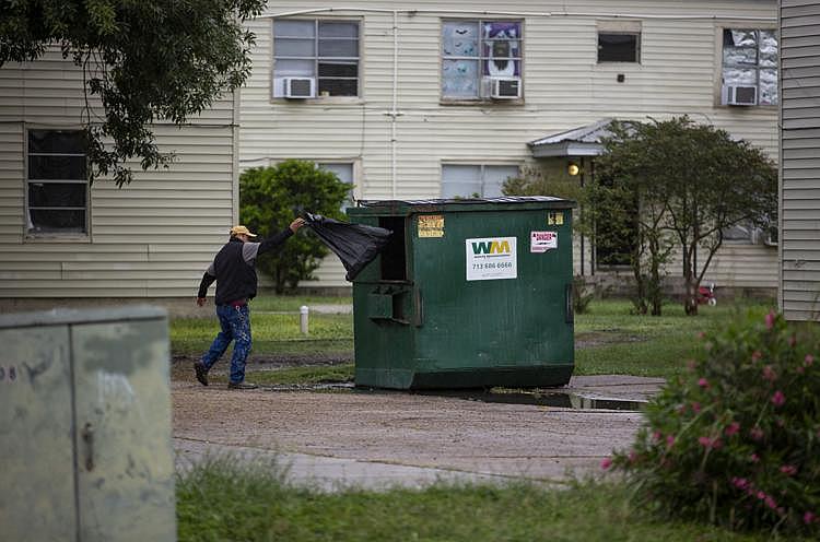 A Crossroads maintenance worker throws a black garbage bag filled with items he collected from Gary and Johnson’s apartment into a dumpster. The bag was one of several that ended up in the garbage. Without giving Gary an exact time, the crew let themselves into her apartment and cleared all of the family’s belongings out in about an hour. (Photo Credit: Angela Piazza/Victoria Advocate) A Crossroads maintenance worker throws a black garbage bag filled with items he collected from Gary and Johnson’s apartment into a dumpster. The bag was one of several that ended up in the garbage. Without giving Gary an exact time, the crew let themselves into her apartment and cleared all of the family’s belongings out in about an hour.