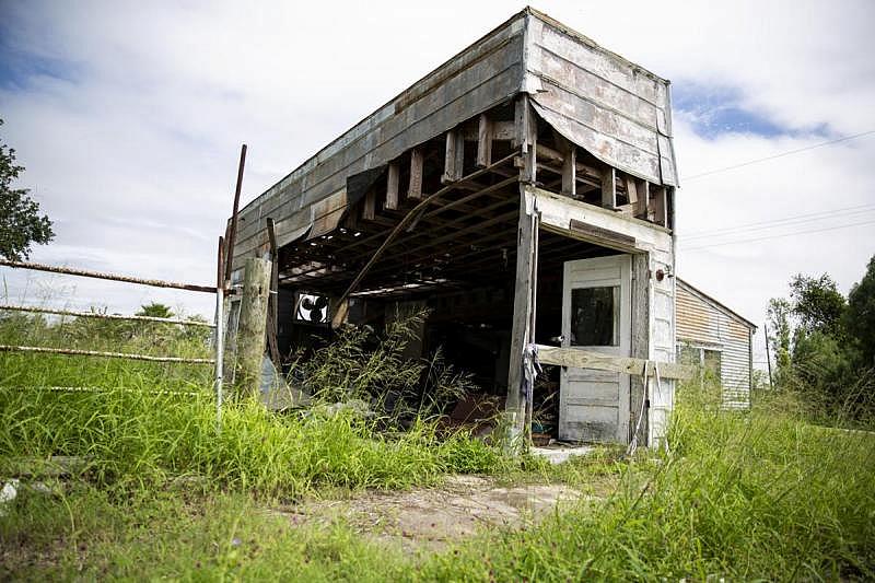 A gaping hole in the side of Bayside’s old grocery store building reveals abandoned antiques and other items. Residents say many years ago, it was one of two stores in town. Now, the nearest grocery store is about 17 miles away.