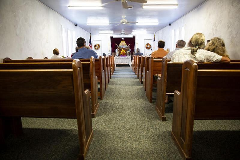 The Rev. Bill Lindsey preaches to a small congregation of about 20 at First Baptist Church. Before Hurricane Harvey, the modest church had around 35 parishioners. It is the only operational place of worship in town after Harvey's devastation.