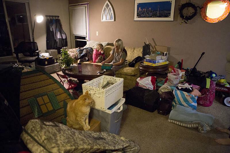 Sabrina and Aroara in their friends' living room, where they have stayed since the wildfire reduced their home to ashes. (Anne Wernikoff/KQED)