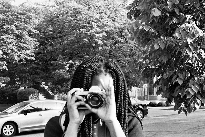 Adora Ezepue, 15, practices with her 35 mm film camera in University Circle. Photo by Isadora Waller