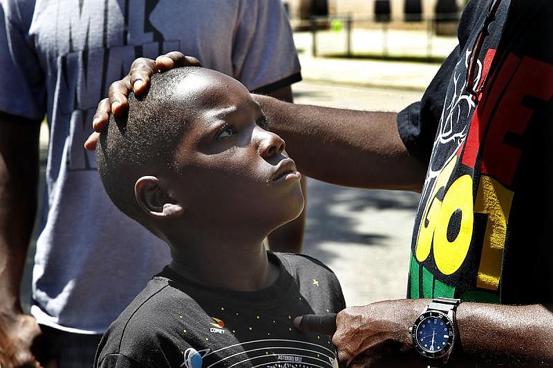 Andre Lee Ellis, founder of "We Got This," gives Nicholas Johnson, 9, a rebuke on a Saturday in June. Ellis is known for his stern approach, but at the same time often tells the boys they are special and he loves them – words he says they don't hear often enough.