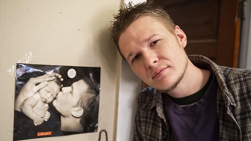 Travis Litts stands in his bedroom next to a picture of himself kissing his son. Litts lost custody of his son and hit his former girlfriend when he was high in an Allentown hospital nearly two years ago. Rick Kintzel / The Morning Call