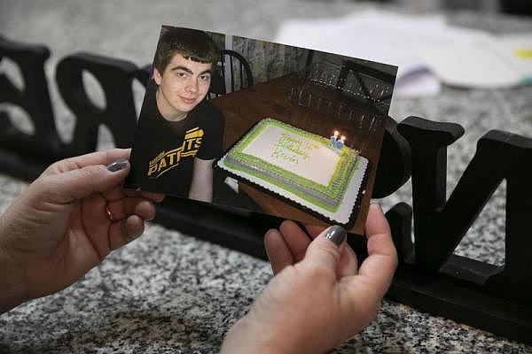 HEATHER KHALIFA / STAFF PHOTOGRAPHER Joanne Endrick holds a photo of her son Kevin celebrating his 16th birthday.