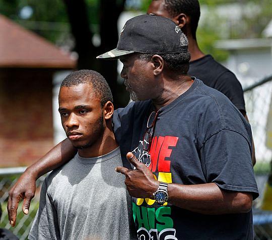 Andre Lee Ellis, founder and director of "We Got This," comforts Devin Bell, 17, who shared with his peers some of his struggles during the "We Got This" summer program in June. (Photo: Angela Peterson/Milwaukee Journal Sentinel)