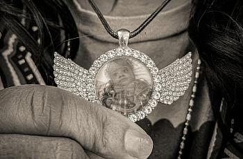 Image of a person showing their pendant