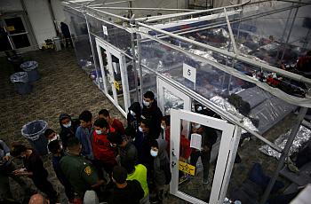 Minors talk to an agent outside a pod at the Department of Homeland Security holding facility run by the Customs and Border Patr