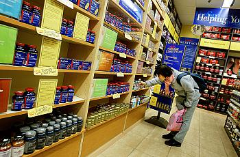 A shopper browses supplements at a GNC vitamin store in New York City.