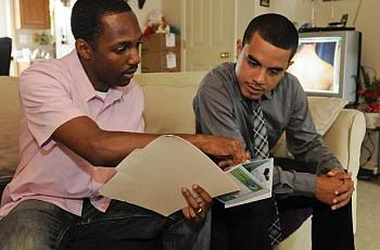Victor Murray, intervention specialist for Camden GPS, a violence-prevention program, meets with assault victim Miguel Malave