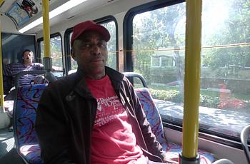 Leaburn Alexander works two jobs and does not have health insurance. Here, he is on the start of his 3-hour commute home from the job he works as an overnight hotel janitor. (Lisa Morehouse/KQED)