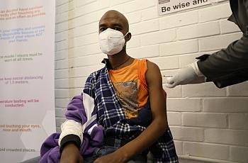 A volunteer participating in Oxford’s COVID-19 vaccine trial receives a shot in South Africa on June 24.