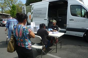 Morgan Smith, a registered nurse with the Redwood Empire Food Bank Diabetes Wellness Project, conducts free diabetes screenings once a month at the Graton Day Labor Center. The center serves as a conduit between its members — many of whom are undocumented — and health organizations around the region. (Lisa Morehouse/KQED)