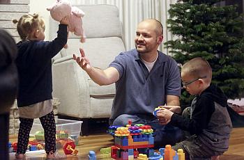 Dustin Wallis, a nonsmoker who has stage 4 lung cancer, plays with his children in Cottonwood Heights, Utah.