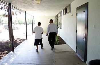 Teacher and student walk down hallway